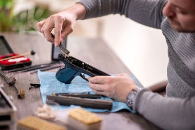 Gunsmith disassembling and servicing a handgun