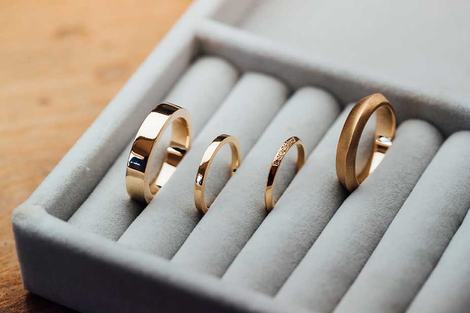 Gold rings and bands arranged in a jewelry tray